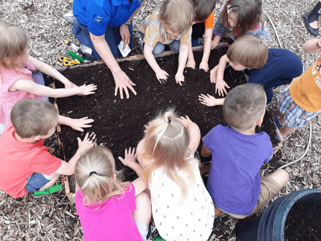 Preschool children playing in soil